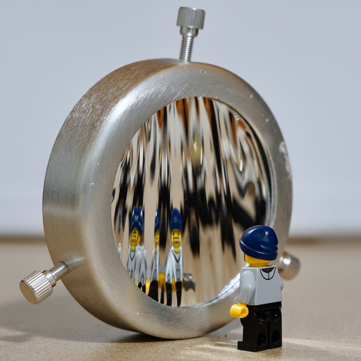 Lego minifig posed in front of shiny material